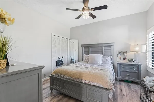 a bedroom with a bed and a potted plant