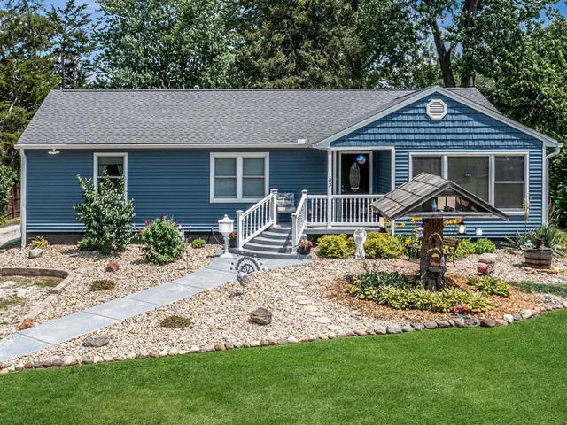 a front view of a house with garden