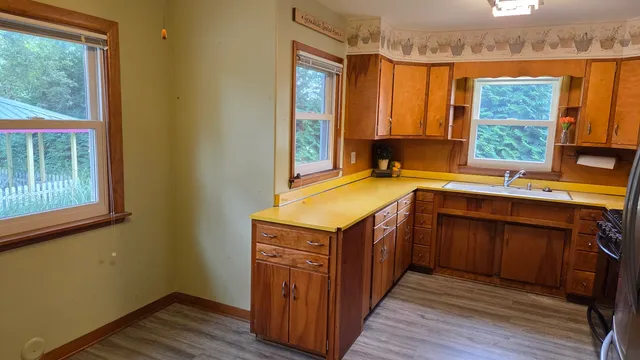 a kitchen with a stove sink and cabinets