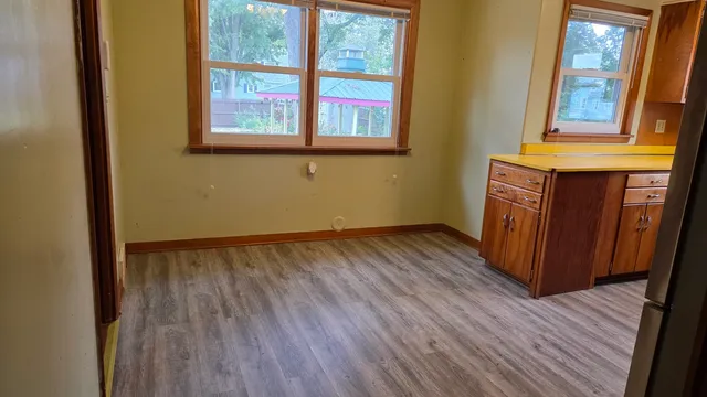 a view of an entryway with wooden floor