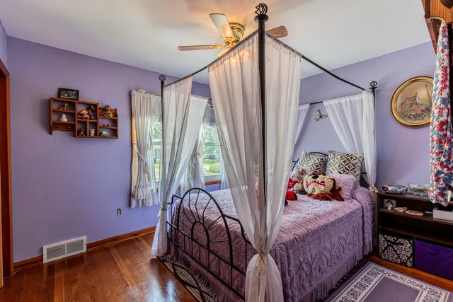 a bed sitting in a bedroom next to a window
