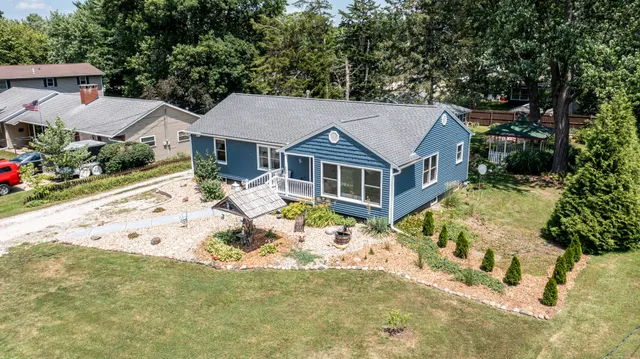an aerial view of a house with a yard and garden