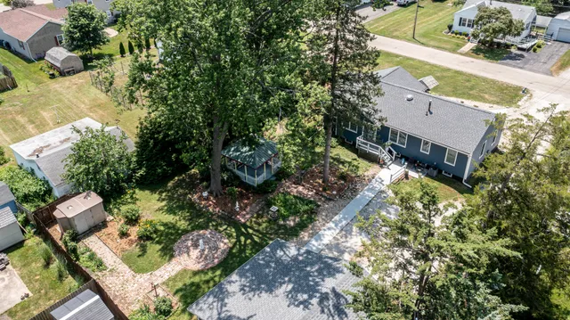an aerial view of house with yard and swimming pool