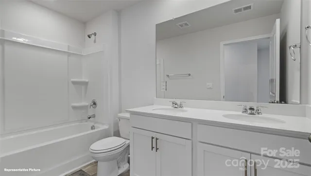 a view of an empty room with window and closet area