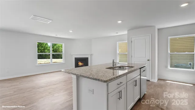 a open kitchen with granite countertop a sink and a window