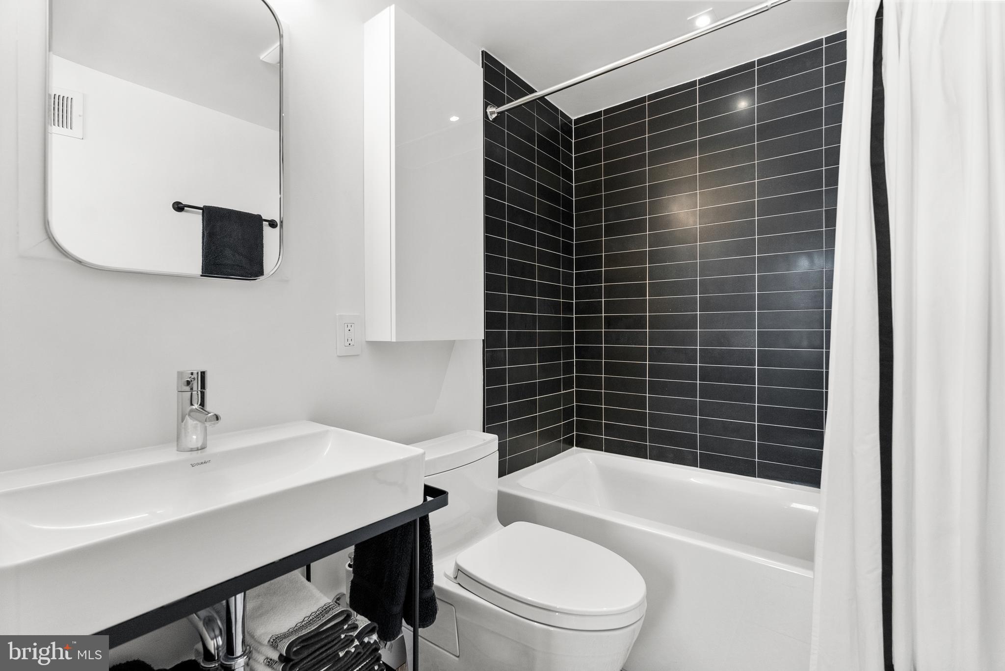 3210 Grace Street Northwest, Unit 304 Washington, DC 20007 - Photo 25 of 41 a bathroom with a sink toilet and shower