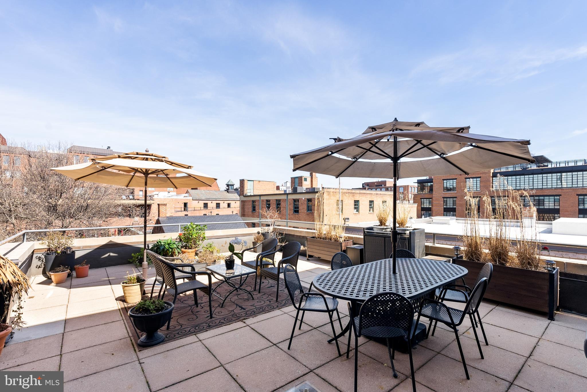 3210 Grace Street Northwest, Unit 304 Washington, DC 20007 - Photo 30 of 41 a view of a terrace with furniture and umbrella