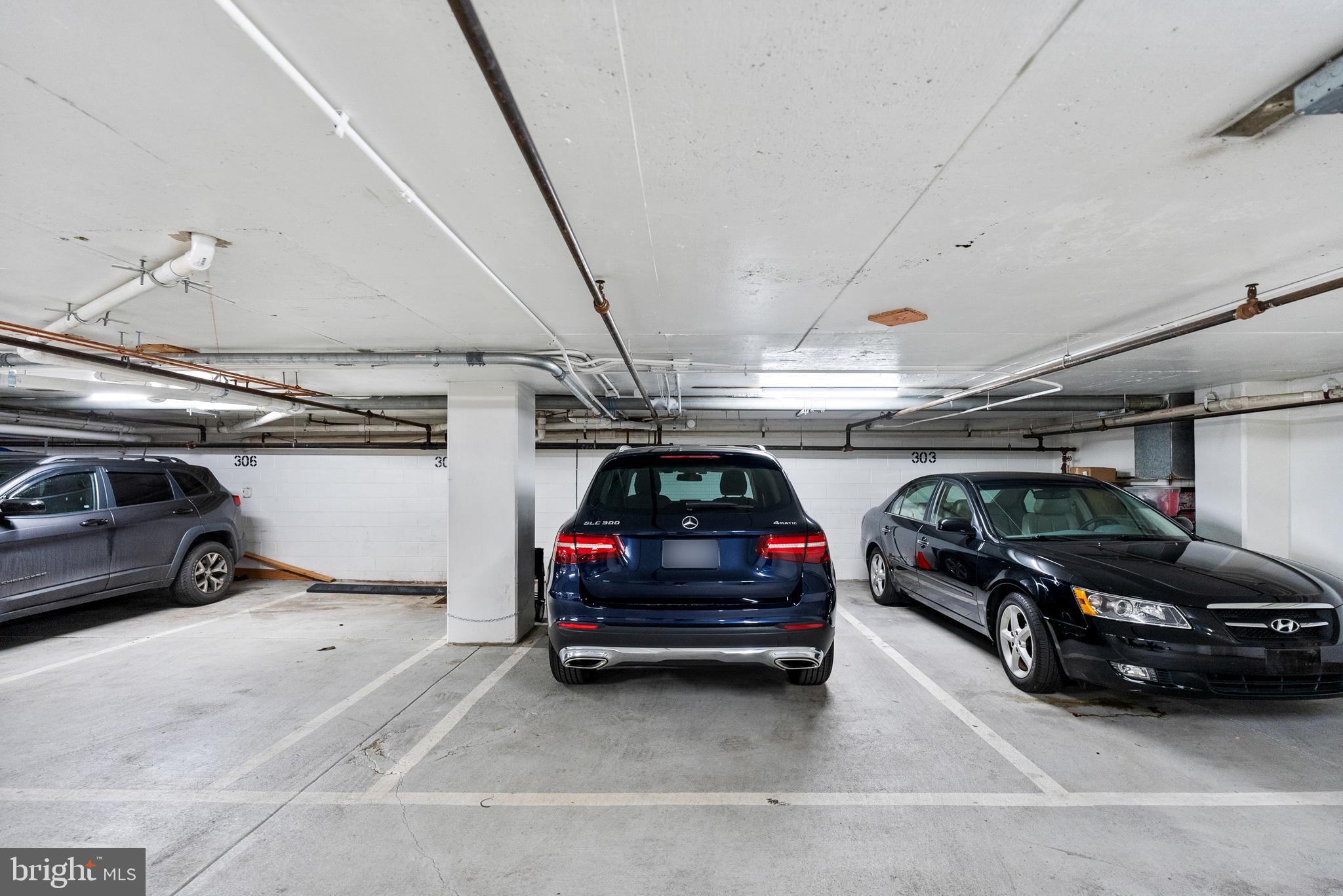3210 Grace Street Northwest, Unit 304 Washington, DC 20007 - Photo 33 of 41 a view of parking garage with cars parked