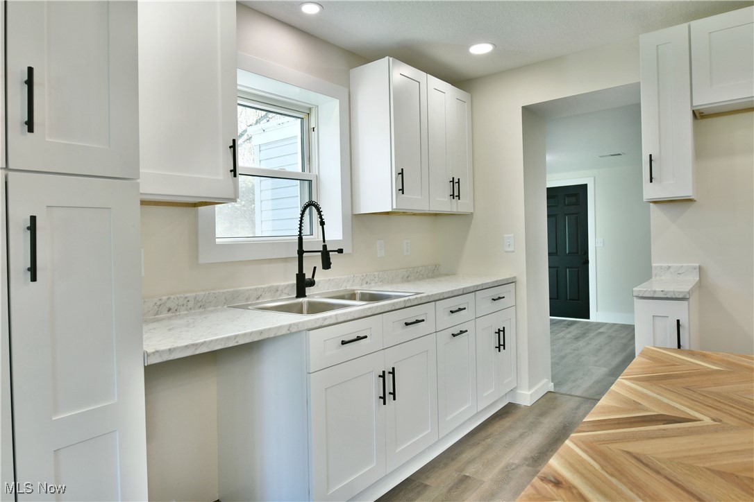 2096 Stillwagon Road Southeast Warren, OH 44484 - Photo 6 of 50 Kitchen with a sink, recessed lighting, and white cabinetry