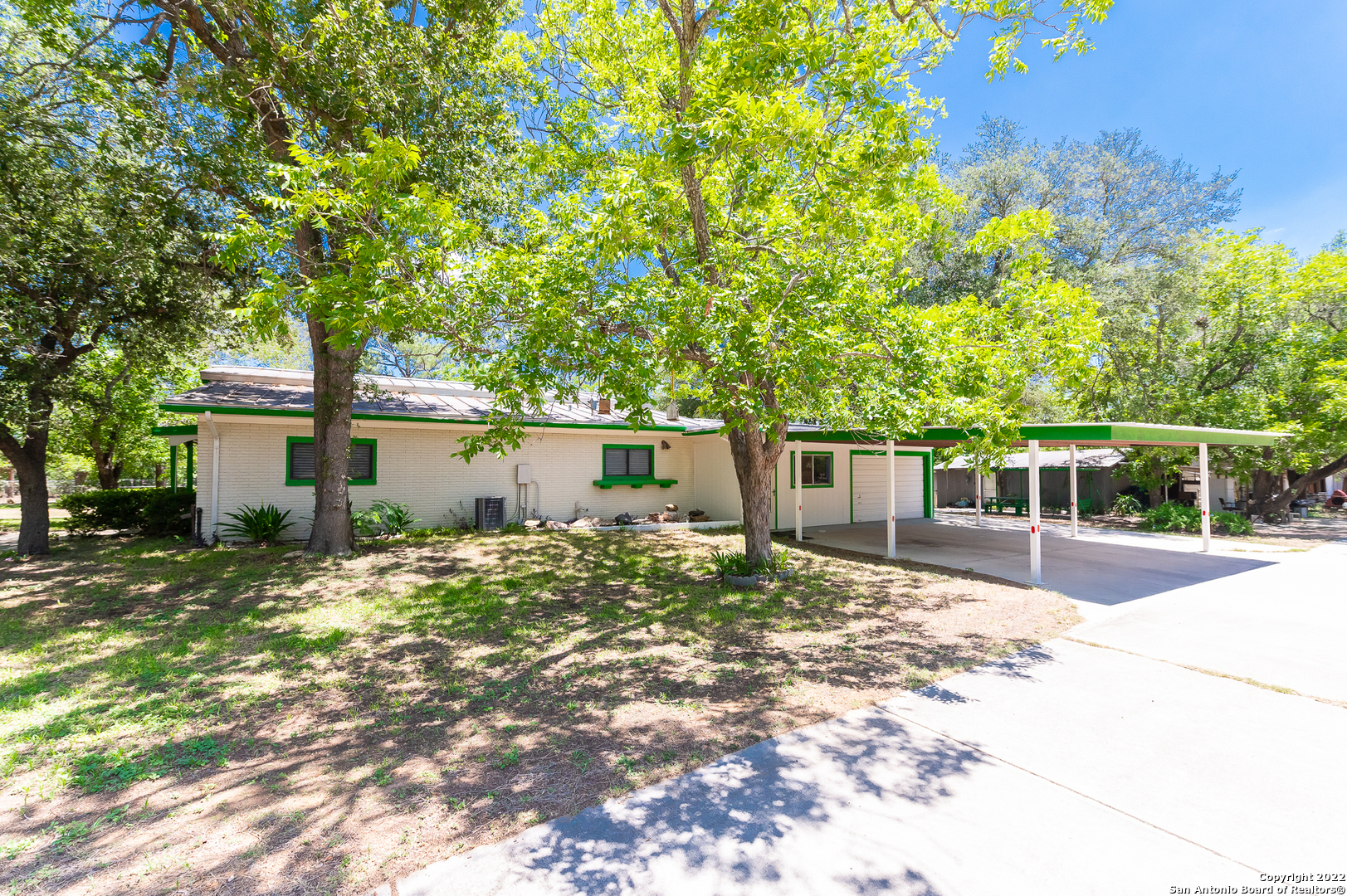 a backyard of a house with table and chairs