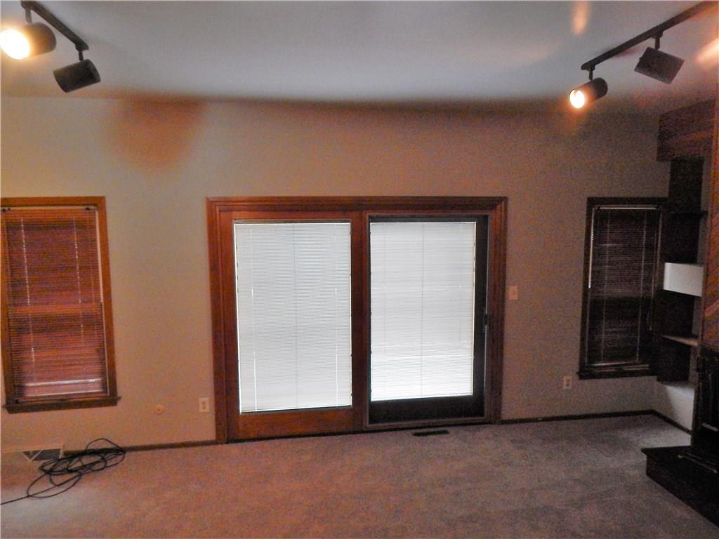 220 Falls Village Road Pittsburgh, PA 15239 - Photo 11 of 24 ANOTHER VIEW OF THE LIVING ROOM WITHSLIDING DOORS TO A DECK OVERLOOKING THEWOODED REAR YARD.