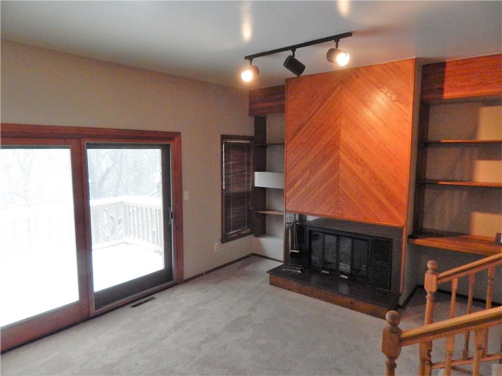 220 Falls Village Road Pittsburgh, PA 15239 - Photo 10 of 24 SUNKEN LIVING ROOM WITH TRACK LIGHTING AND A FIREPLACE TO KEEP YOU WARM.