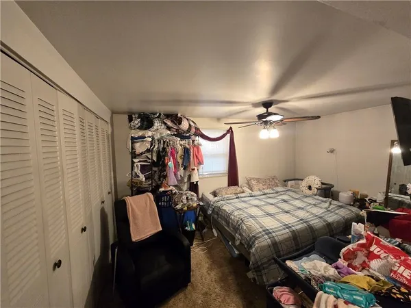 a bedroom with bed and a mirror