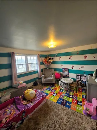 a room with lots of baby toys and wooden floor