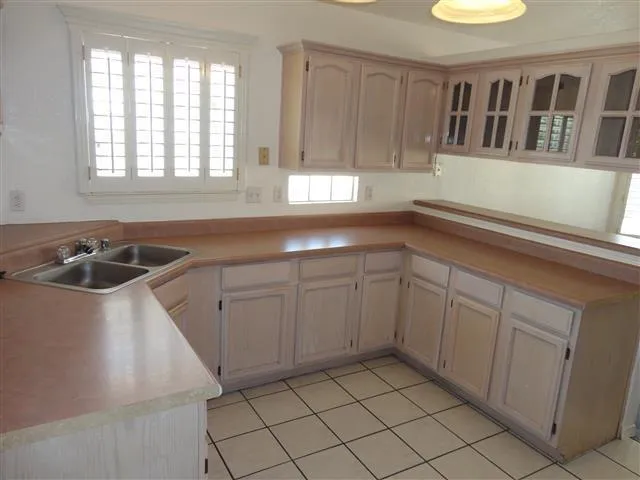 a kitchen that has a sink and cabinets