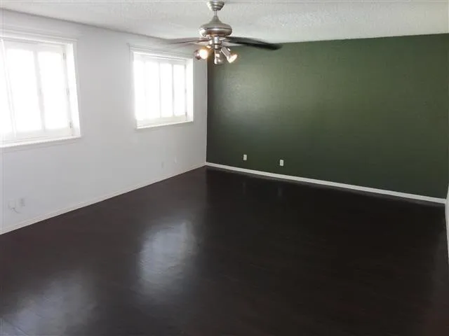 a view of room with window and hardwood floor