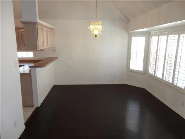 a view of a livingroom with wooden floor and a window