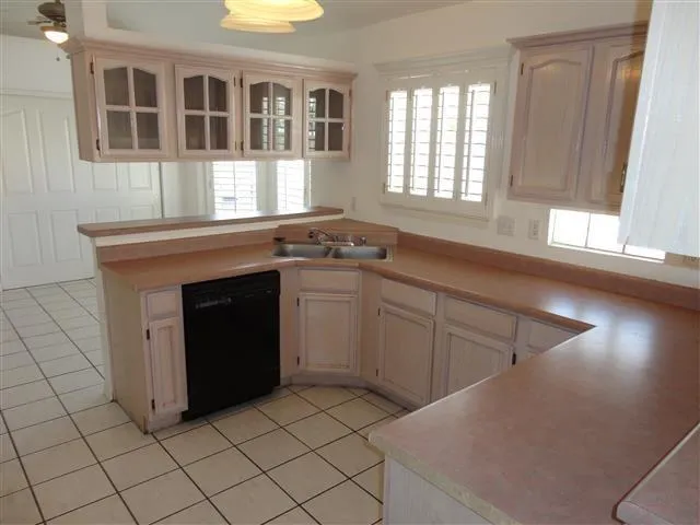 a kitchen with stainless steel appliances granite countertop a stove a sink and a window