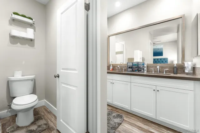 a bathroom with a toilet sink and mirror