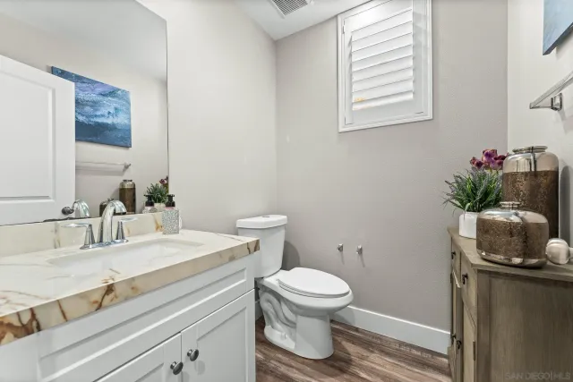 a bathroom with a sink toilet and a mirror