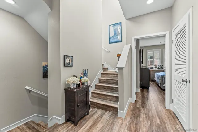 a view of hallway with wooden floor and stairs