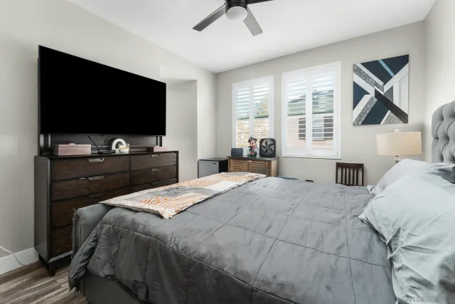 a bedroom with a bed and a flat screen tv