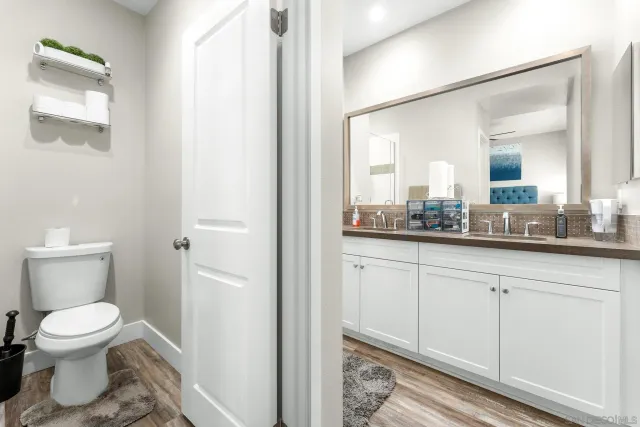 a bathroom with a toilet sink and mirror