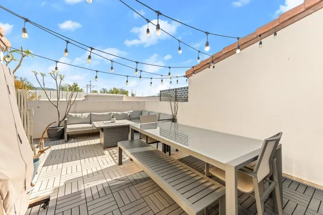 a view of a living room with a table and chairs