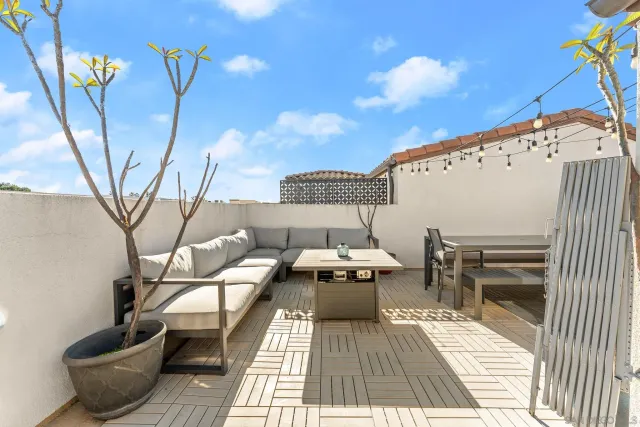 a terrace with outdoor seating and city view