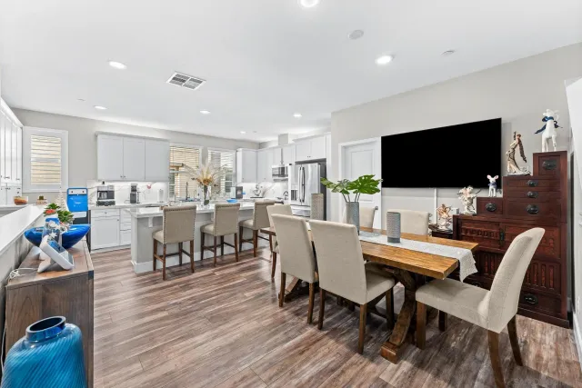 a view of a dining room with furniture and wooden floor