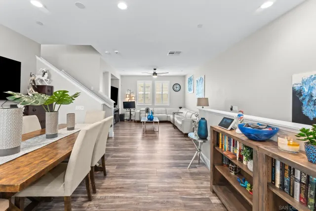 a living room with furniture and a book shelf