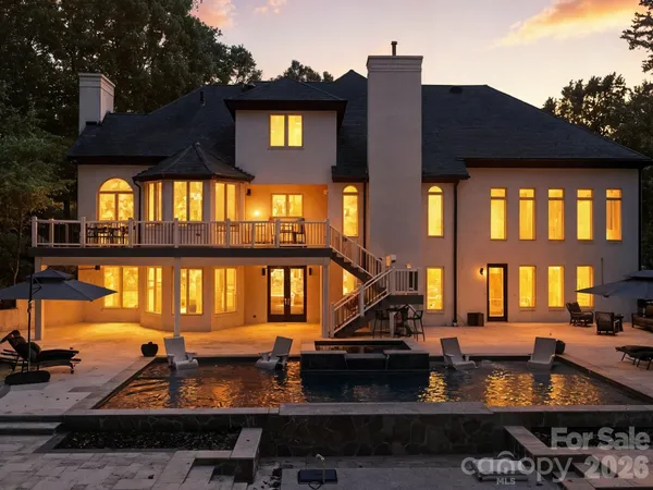 a view of a house with swimming pool and sitting area