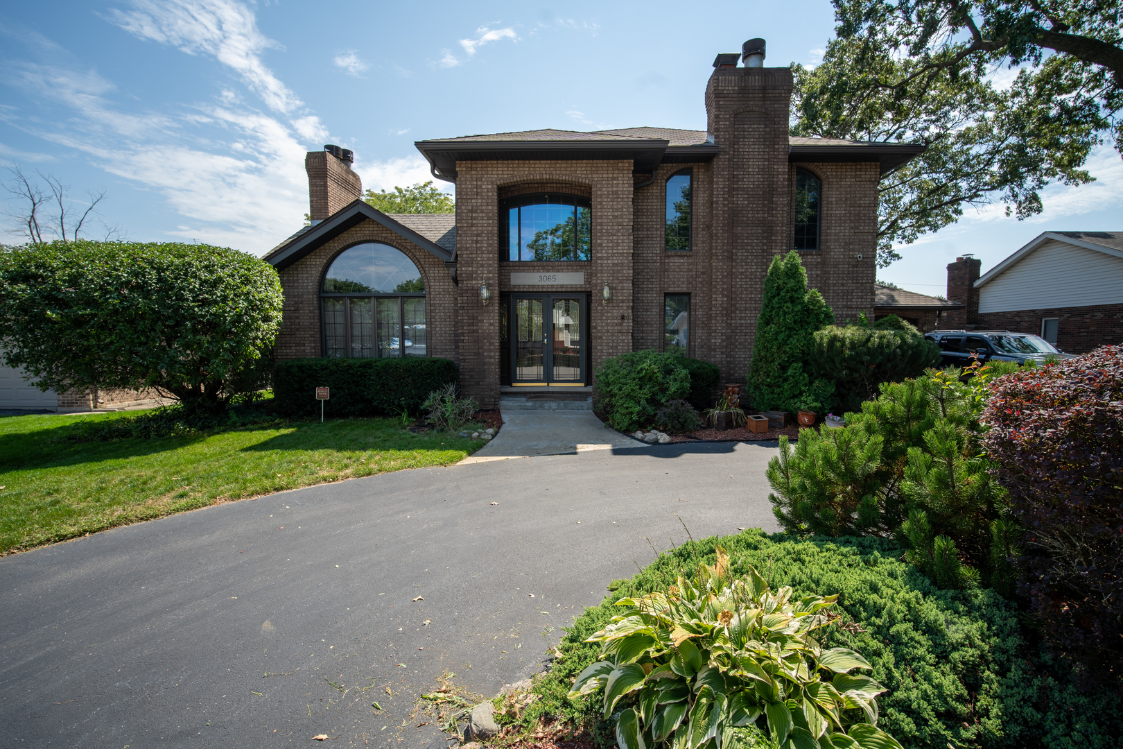 3065 182nd Place Lansing, IL 60438 - Photo 1 of 38 a front view of a house with garden