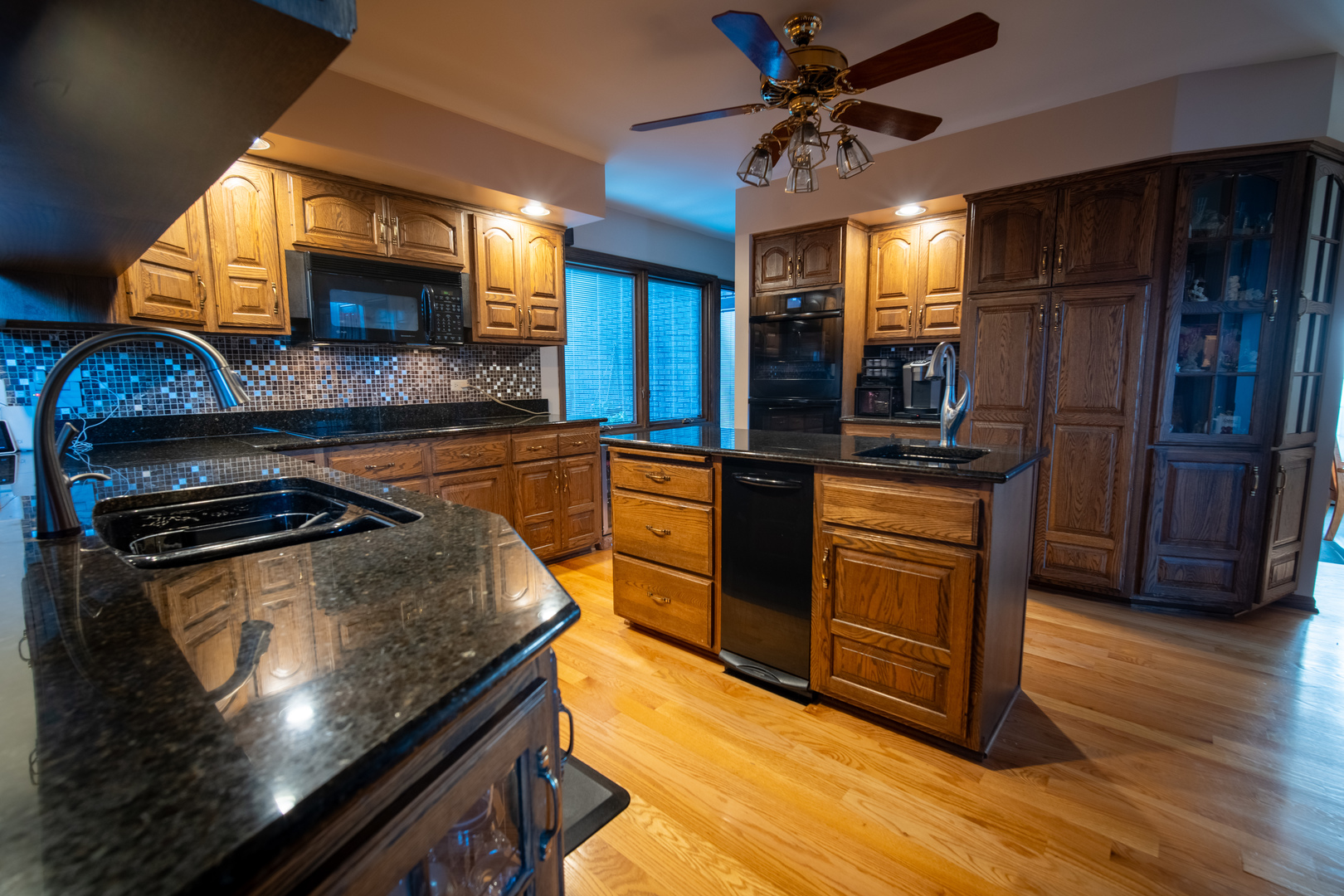 3065 182nd Place Lansing, IL 60438 - Photo 12 of 38 a kitchen with stainless steel appliances granite countertop a stove a sink and a microwave