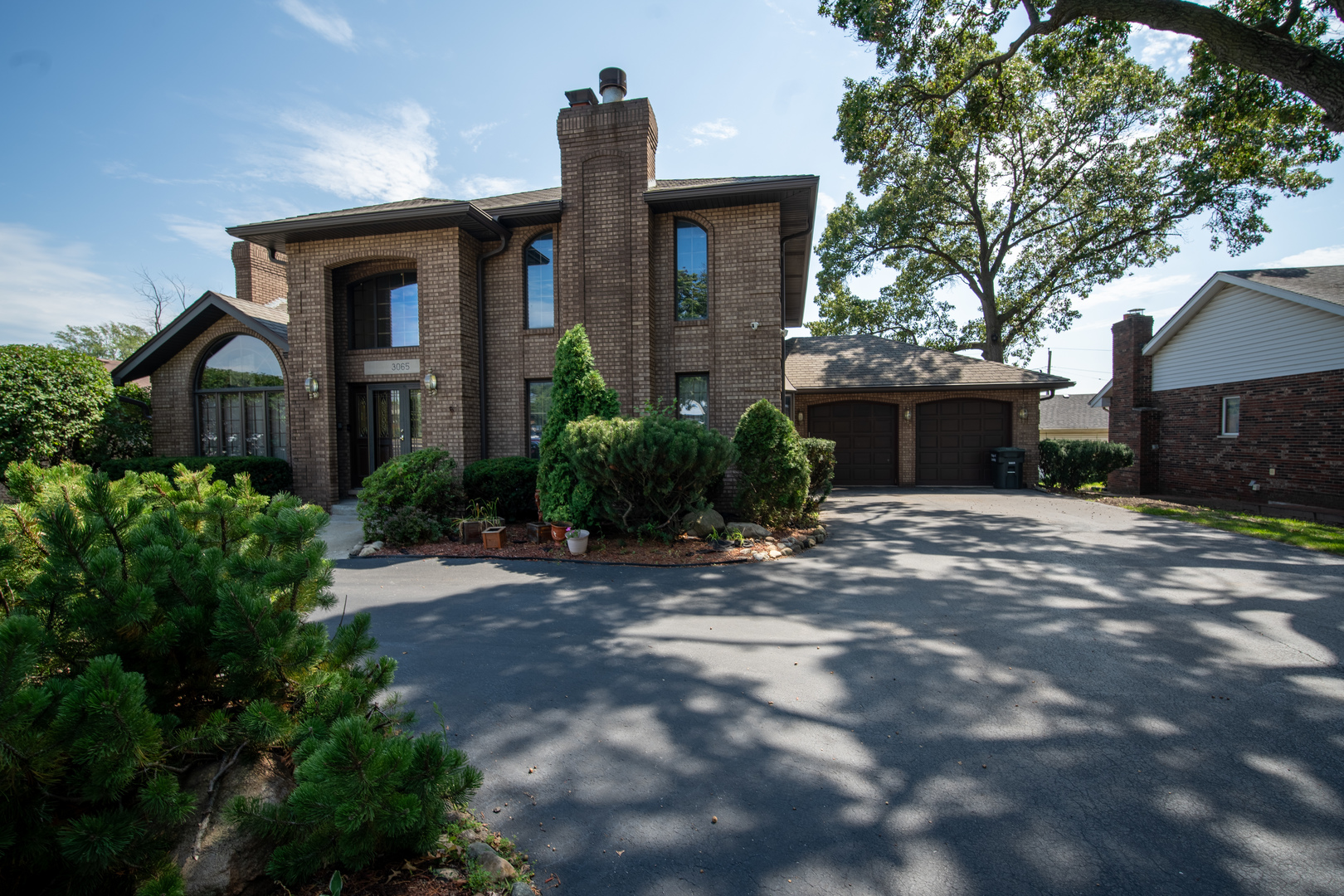 3065 182nd Place Lansing, IL 60438 - Photo 2 of 38 a front view of a house with garden