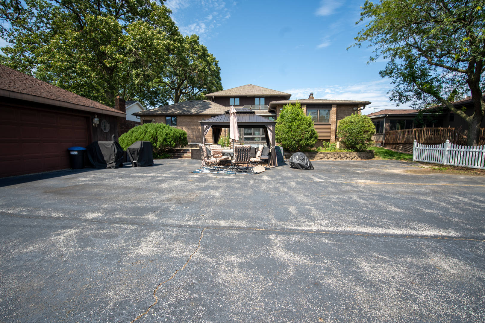 3065 182nd Place Lansing, IL 60438 - Photo 4 of 38 a view of a patio with a table and chairs under an umbrella