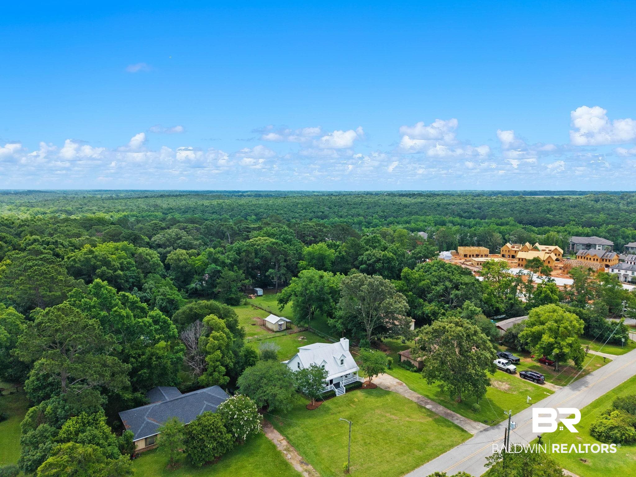 22810 High Ridge Road Fairhope, AL 36532 - Photo 73 of 78 Aerial perspective showcasing a residential property with a white exterior and dark roof