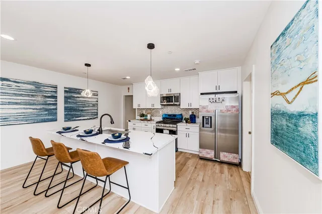a bedroom with a large bed and a potted plant