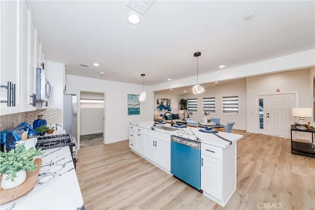 a view of hallway with wooden floor and a potted plant