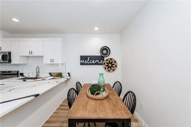 a view of a bedroom with wooden floor and a window