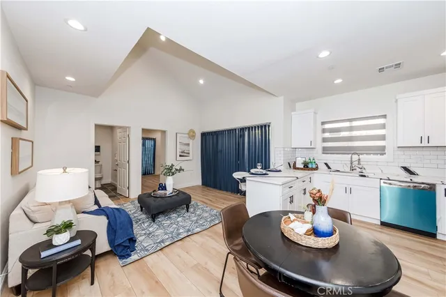 a living room with furniture and kitchen view