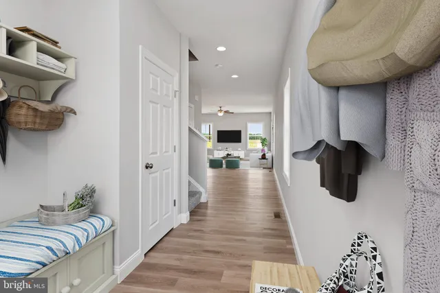 a hallway with a couch and chandelier