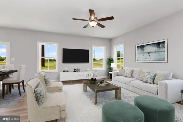 a living room with furniture kitchen view and a flat screen tv