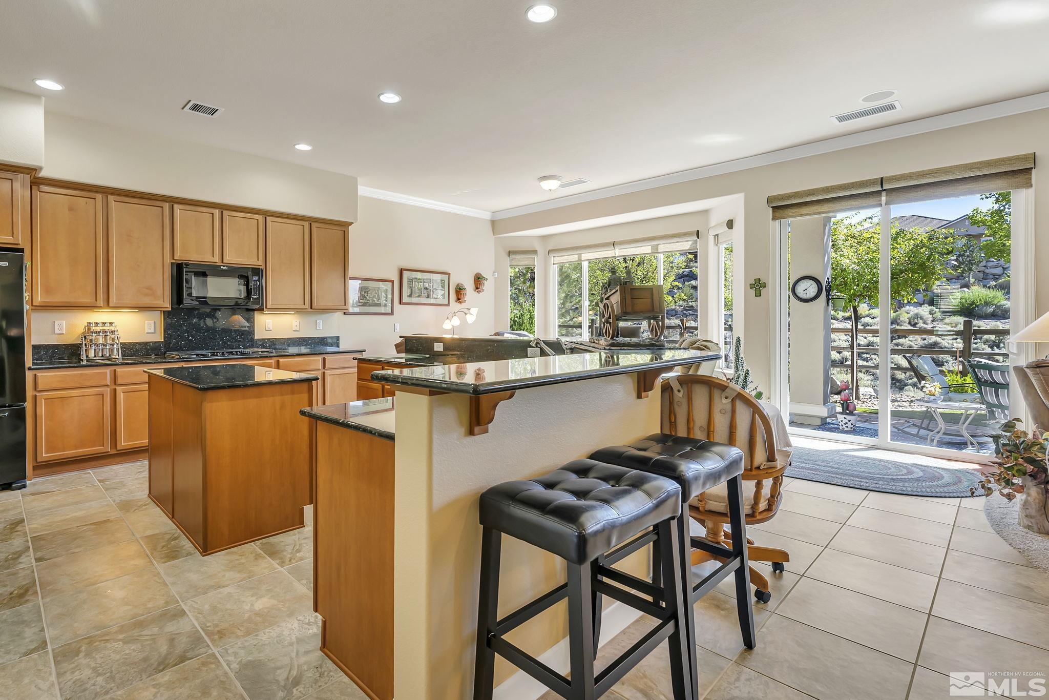 1320 Winterchase Way Reno, NV 89523 - Photo 11 of 37 a kitchen with stainless steel appliances granite countertop table chairs sink and cabinets