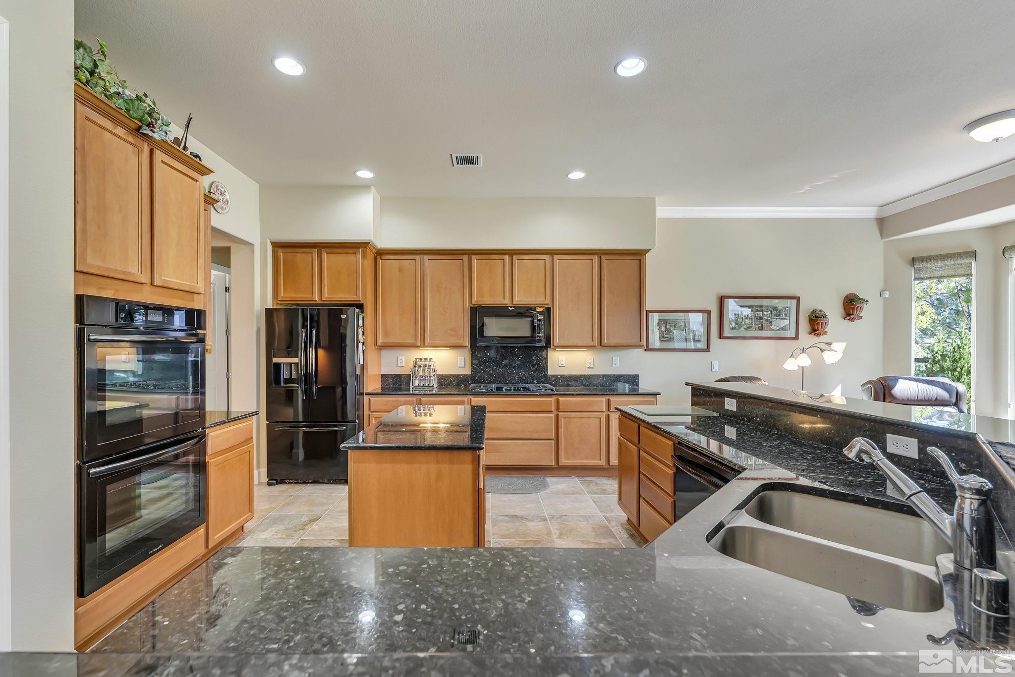 1320 Winterchase Way Reno, NV 89523 - Photo 12 of 37 a kitchen with stainless steel appliances granite countertop a refrigerator and a sink