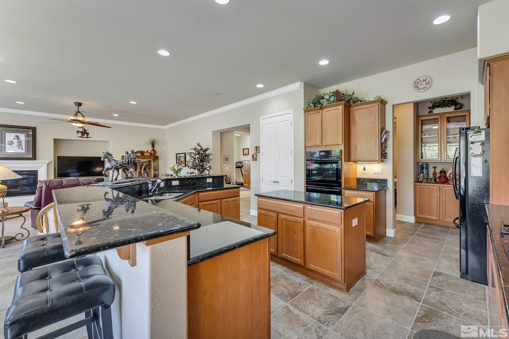 1320 Winterchase Way Reno, NV 89523 - Photo 15 of 37 a kitchen with stainless steel appliances granite countertop sink stove refrigerator and cabinets