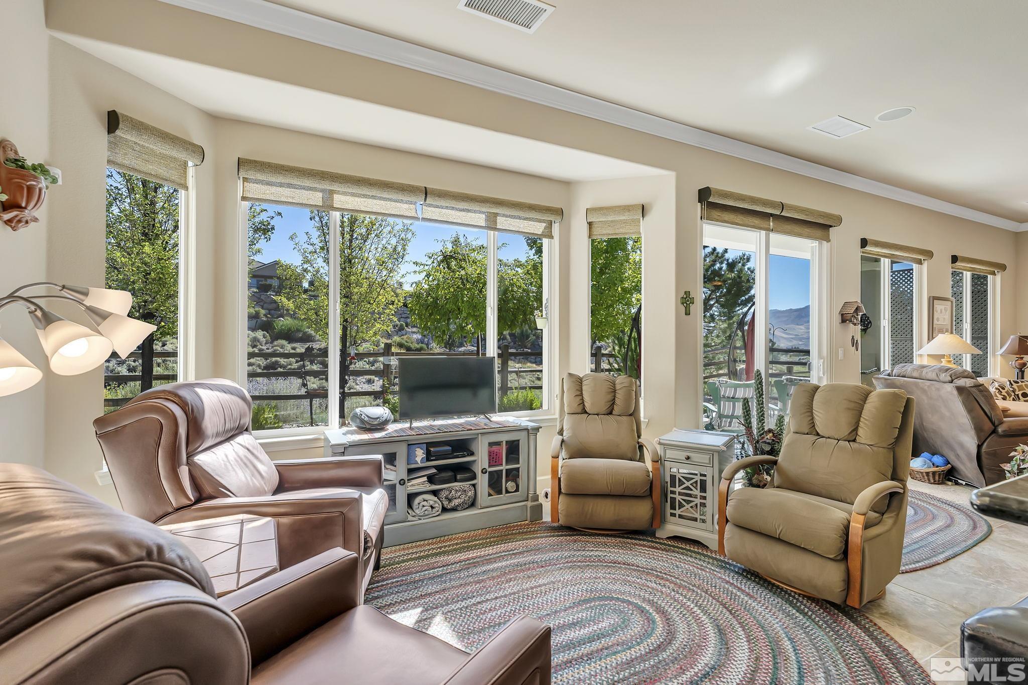 1320 Winterchase Way Reno, NV 89523 - Photo 17 of 37 a living room with furniture floor to ceiling window and a flat screen tv