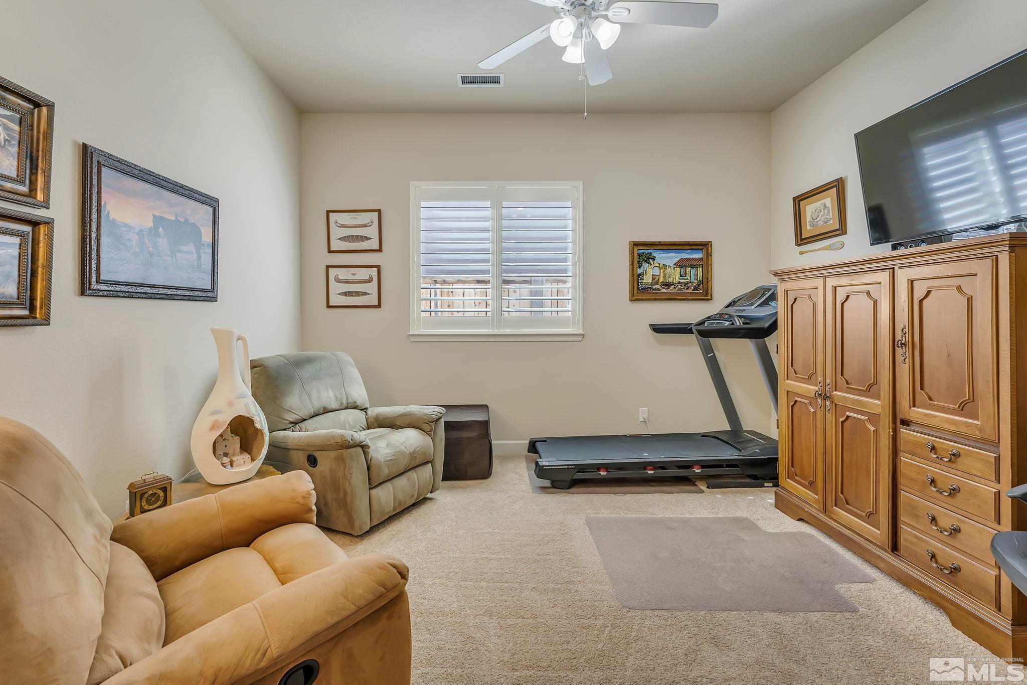 1320 Winterchase Way Reno, NV 89523 - Photo 18 of 37 a living room with furniture gym equipment and a window