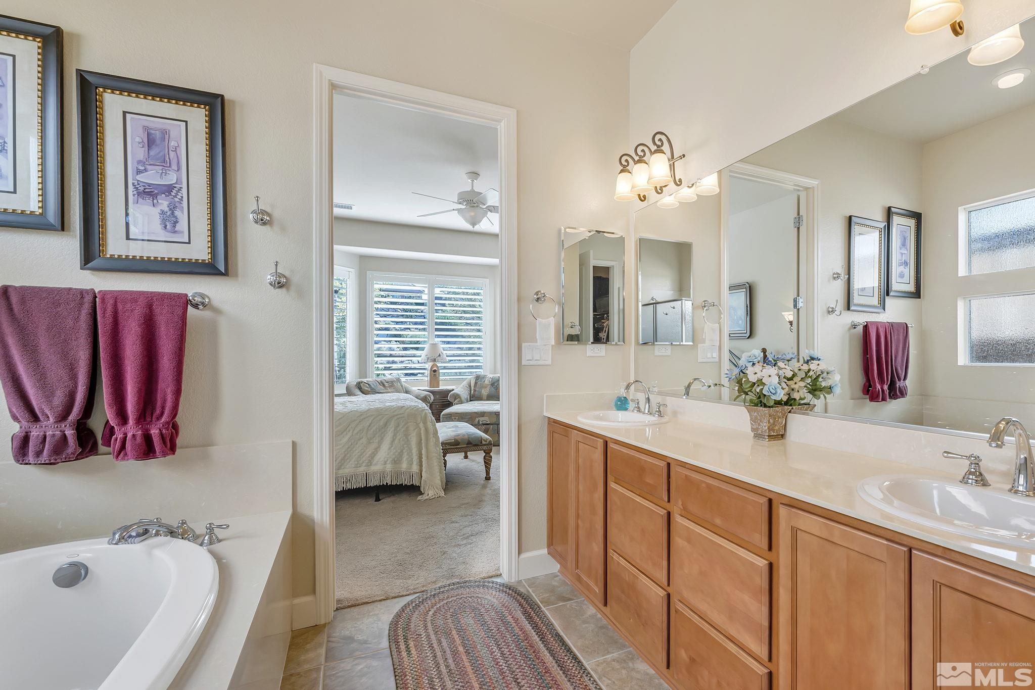 1320 Winterchase Way Reno, NV 89523 - Photo 23 of 37 a en suite spacious bathroom with a bathtub sink and mirror
