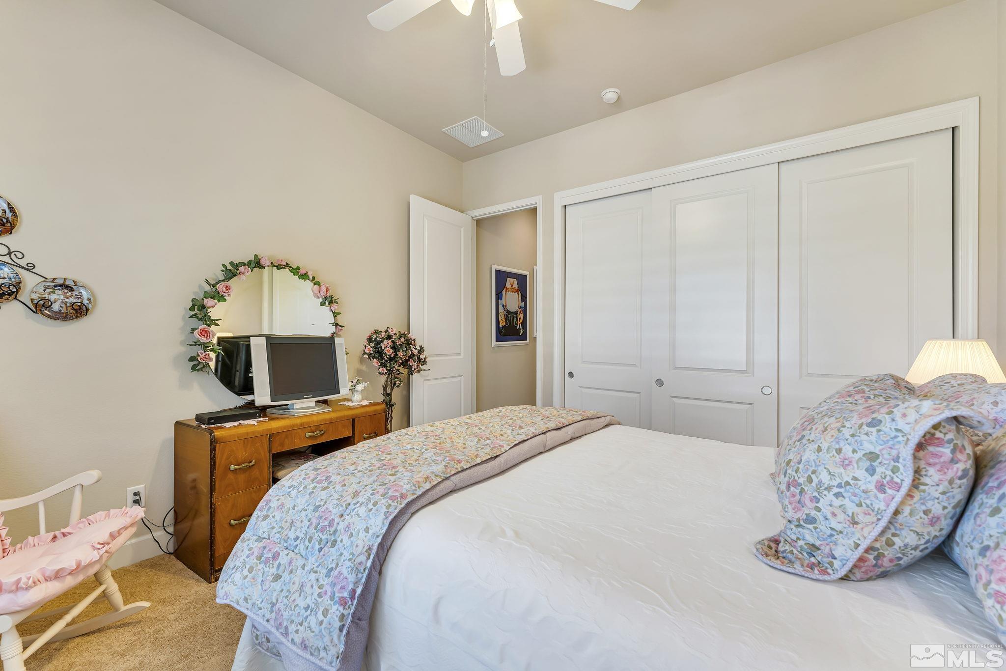 1320 Winterchase Way Reno, NV 89523 - Photo 25 of 37 a bedroom with a bed and a chandelier